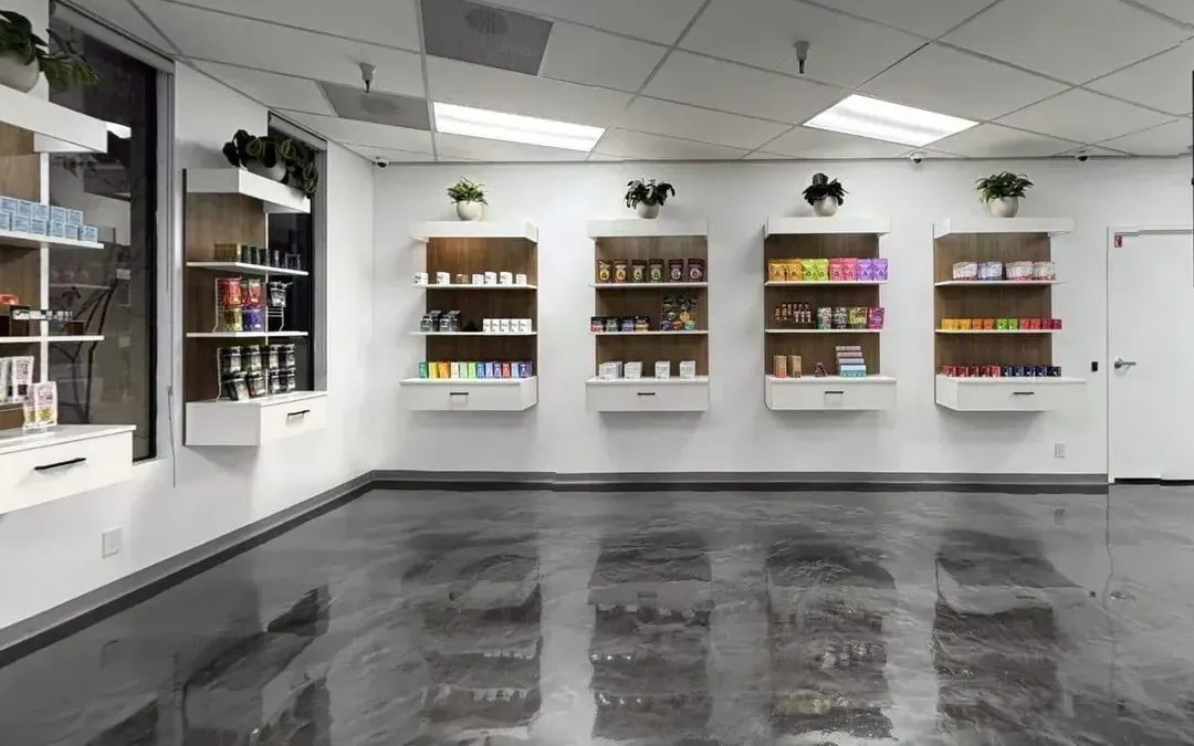 Bright dispensary interior with white shelves and polished concrete floor