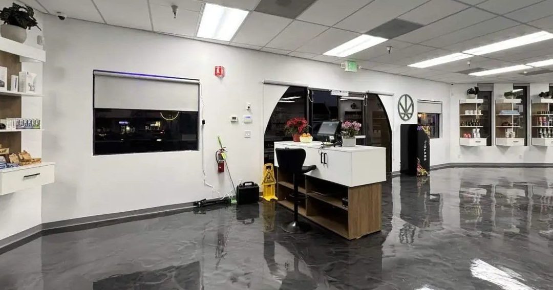 Dispensary sales floor with counter, shelves and reflective flooring